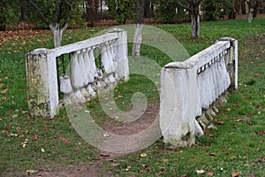 White balusters on a green lawn in an apple orchard