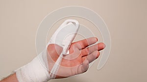 White bandages and a splint on the arm.Broken arm.Bandage and splint on the finger.Bandaged hand.Fractures and sprains