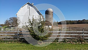 White Barn and Silo with a Wooden Fence