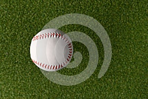 White baseball ball on a green sports field. Minimalism. There are no people in the photo. Abstraction. Professional and amateur