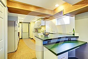 White basement kitchen room with green counter tops