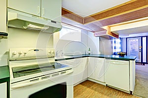 White basement kitchen room with green counter tops