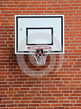 White Basketball Net Mounted on Red Brickwall