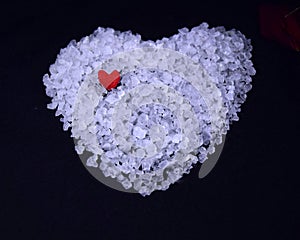 white bath salt heart with a small red heart on it