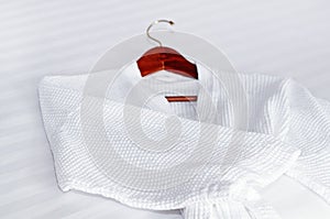 White bathrobe on the bed