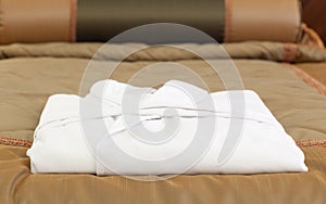 White bathrobe on the hotel bed
