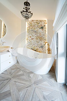 White bathroom with big window and big bathtube photo