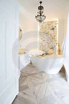 White bathroom with big window and big bathtube photo