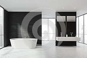 White bathroom with panoramic windows behind black partitions and a bathtub