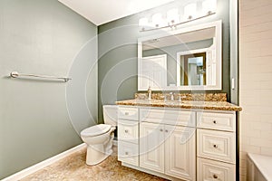 White bathroom vanity cabinet with granite top