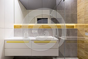 White bathroom with yellow accents photo
