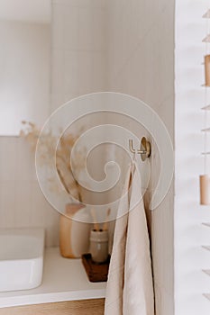 White bathtub in a bathroom interior, with a mirror reflecting off of the wall in the background