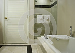 White bathtub with chrome steel taps