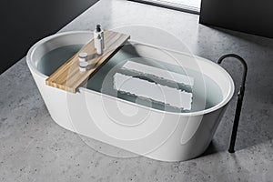 White bathtub in concrete floor bathroom
