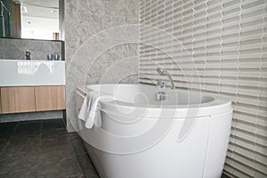 White bathtub in honeymoon suite bedroom in luxury 5 star hotel