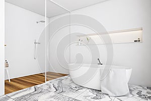 White bathtub with towel and shower
