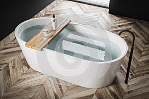 White bathtub in wooden floor bathroom