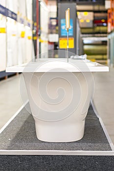 White bathtubs in a hardware store. vertical photo