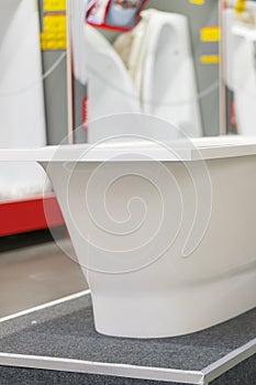 White bathtubs in a hardware store. vertical photo