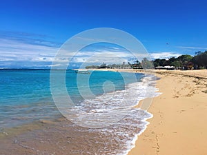 White beach in the daytime with perfect blue sea and clear blue sky