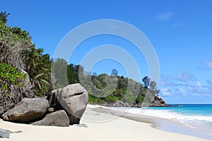 White beach and granite rocks by the sea on Seychelles