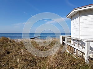 white beach hut at dune landscape