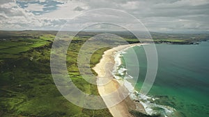 White Beach sand coast aerial zooming, Antrim County, Nortern Ireland. Epic Irish landscape