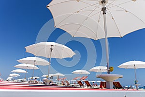 White beach umbrellas on Rimini beach, Italy photo