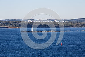 White Beacon and Red Marker in Blue Water