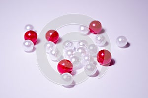 White beads. Beads are red. Separate beads. Placer beads. Beads are bigger and smaller. photo
