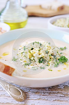 White bean cream soup with fried pearl barley and parsley, bread and olive oil