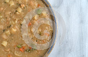 White bean soup in a bowl on a marble table