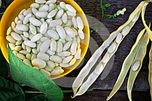 White beans in a cup closeup in focus, top view. Beans with pods