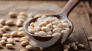 White beans in a spoon on a wooden background.