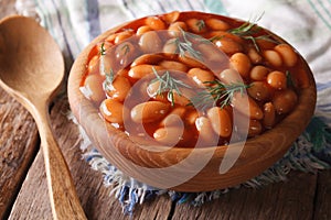 White beans in tomato sauce in a wooden bowl