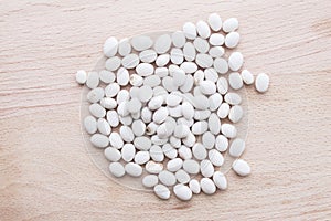 White beans on wooden background