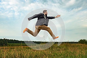 A white bearded man in orange socks flies over the ground