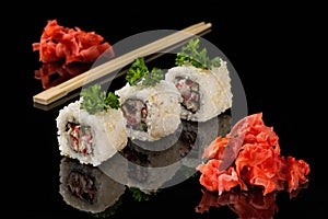 White beaters, wooden sticks for sushi and ginger on black acryle photo