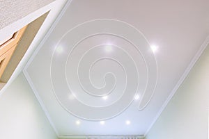 White beautiful matte stretch ceiling in the interior of the hall