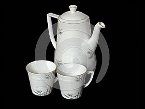 White beautiful tea pot and cups isolated