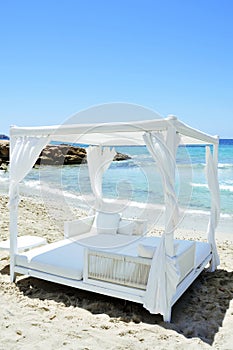 White bed in a beach club in Ibiza, Spain
