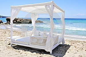 White bed in a beach club in Ibiza, Spain photo