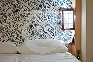 White bed in Japanese hotel room.