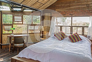 White Bed with Pillow and Work Table in Country Interior Design Room