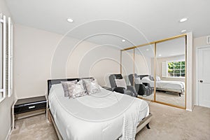 White bedroom with bed, chair, and mirror in Encino, CA