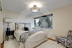 White bedroom furnished with iron bed