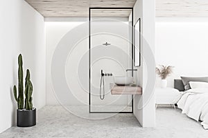White bedroom interior with bathroom and shower