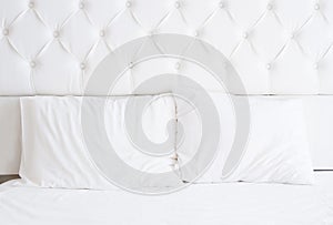 White bedroom interior design with bed and blank pillows. Bedding relax time. Mock up. Copy space