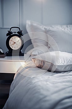 White bedroom with pillows, blanket and white bed and focus on pillows,