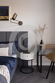 White bedside table in bedroom